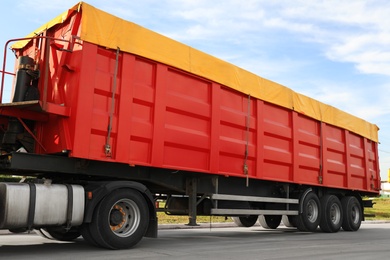 Photo of Modern bright truck parked on country road