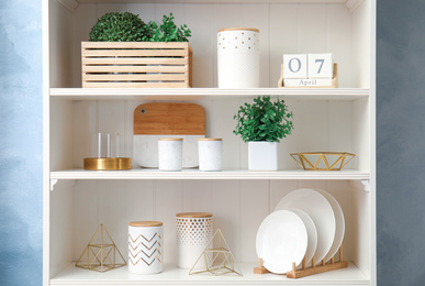 White shelving unit with dishes and different decorative stuff