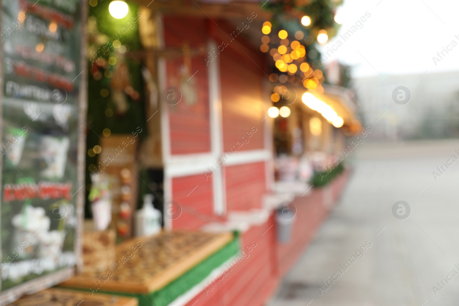 Photo of Blurred view of Christmas fair stalls outdoors