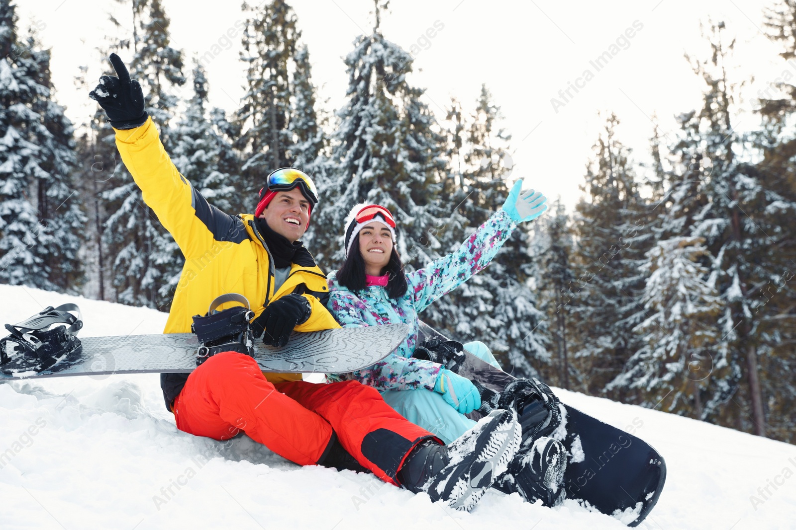 Photo of Happy couple with equipment in snowy mountains. Winter vacation