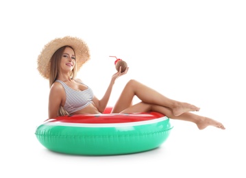 Photo of Sexy young woman in bikini with inflatable ring and coconut cocktail on white background