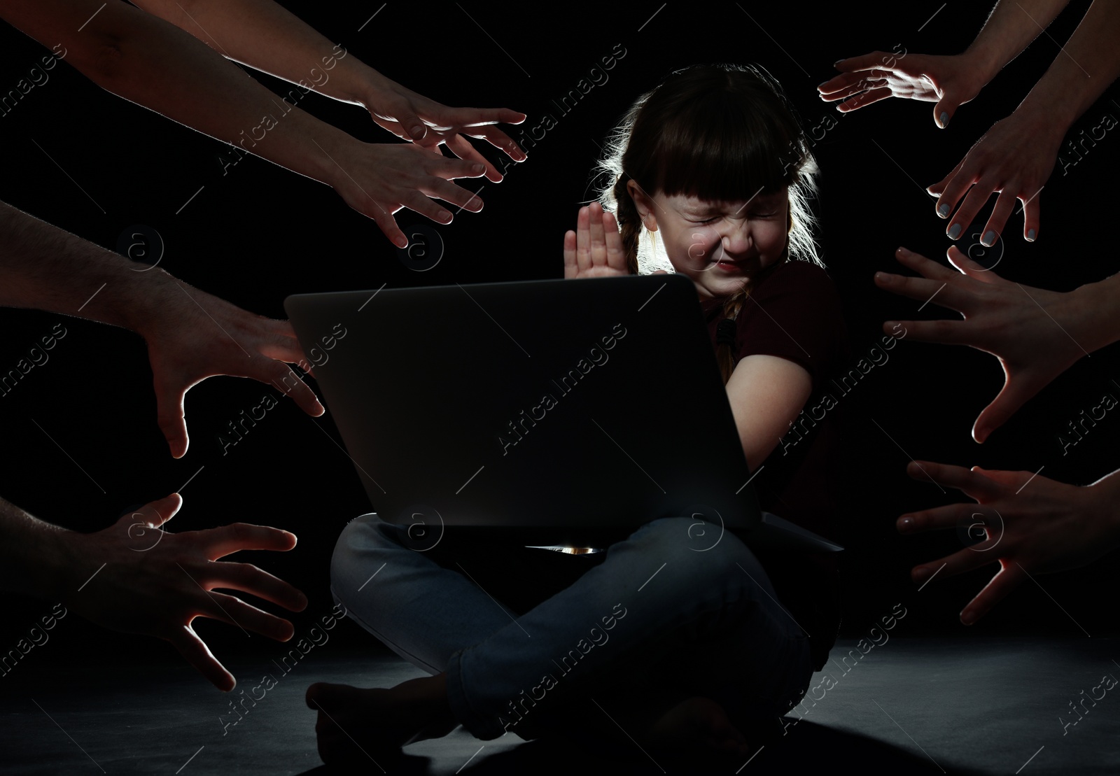 Photo of Strangers reaching frightened little child with laptop on dark background. Cyber danger