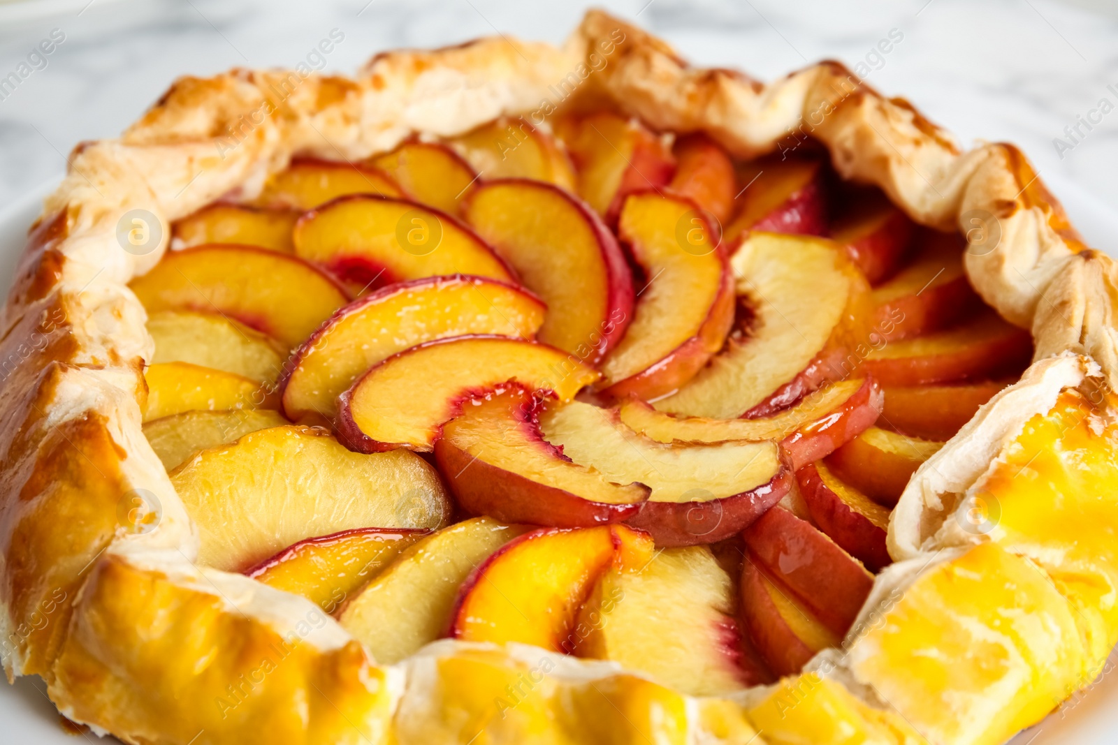 Photo of Delicious fresh peach pie on table, closeup