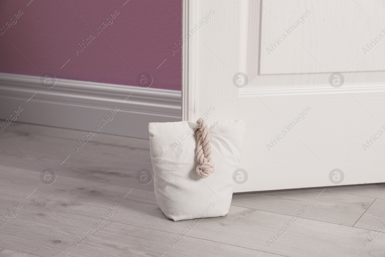 Stuffed bag holding wooden door at home Photo of Stuffed bag holding wooden door at home