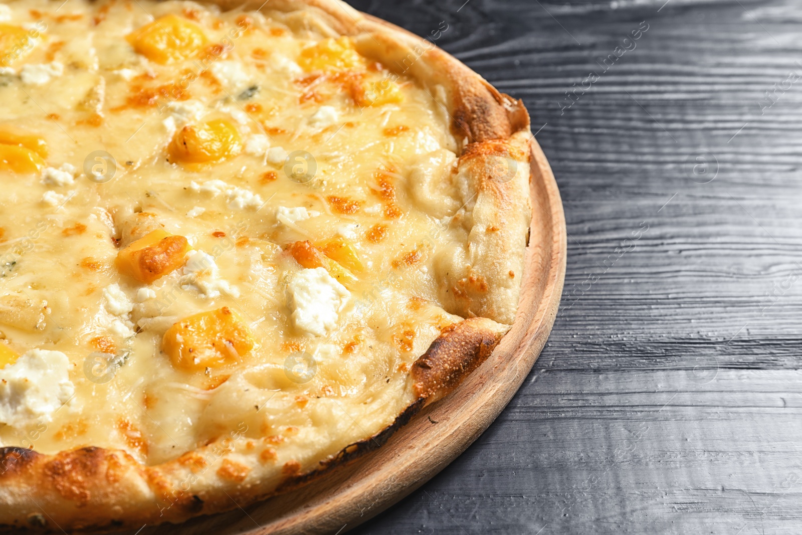 Photo of Hot cheese pizza Margherita on wooden table, closeup