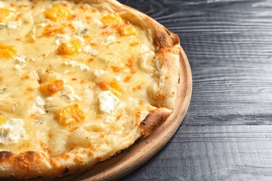 Photo of Hot cheese pizza Margherita on wooden table, closeup