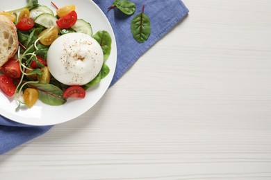 Photo of Delicious burrata salad served on white wooden table, flat lay. Space for text