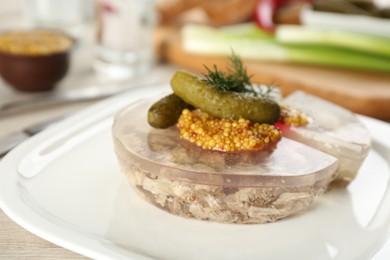 Photo of Delicious aspic with meat and vegetables on plate, closeup