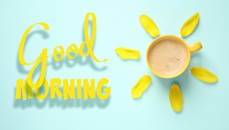 Image of Good Morning. Cup of coffee and tulip petals on light blue background, flat lay