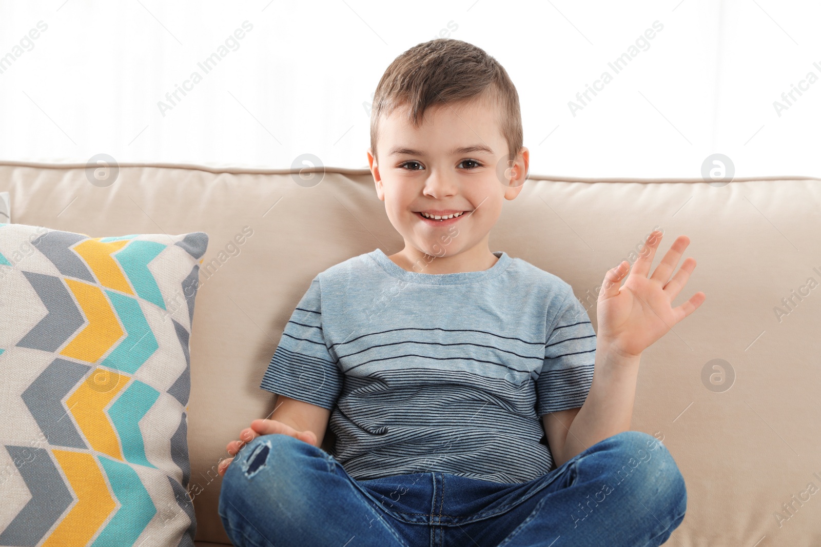 Photo of Little boy using video chat on sofa, view from web camera