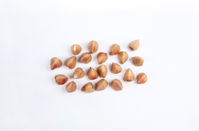 Photo of Uncooked buckwheat on white background, top view