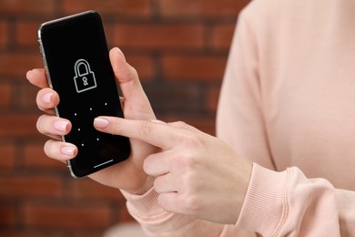 Photo of Woman unlocking smartphone with blocked screen indoors, closeup