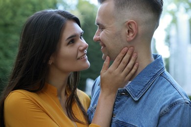 Photo of Happy young couple together near fountain in park