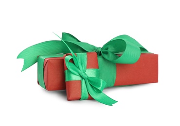 Photo of Christmas gift boxes decorated with green bows on white background