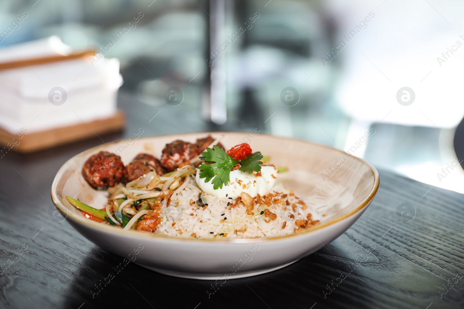 Photo of Plate with rice and meat balls served on table