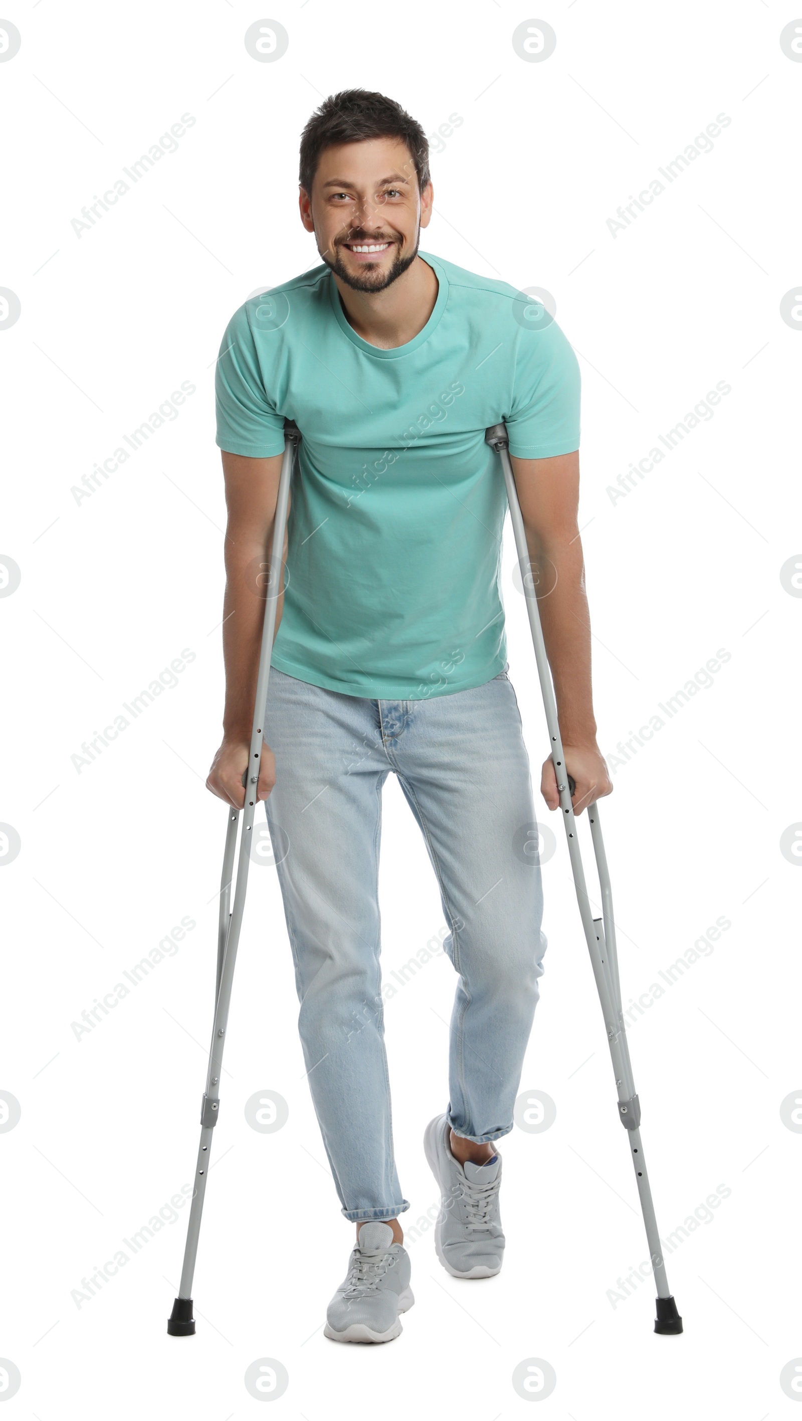 Photo of Full length portrait of man with crutches on white background