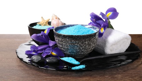 Light blue sea salt in bowls, flowers, starfish, seashell and towel on wooden table against white background