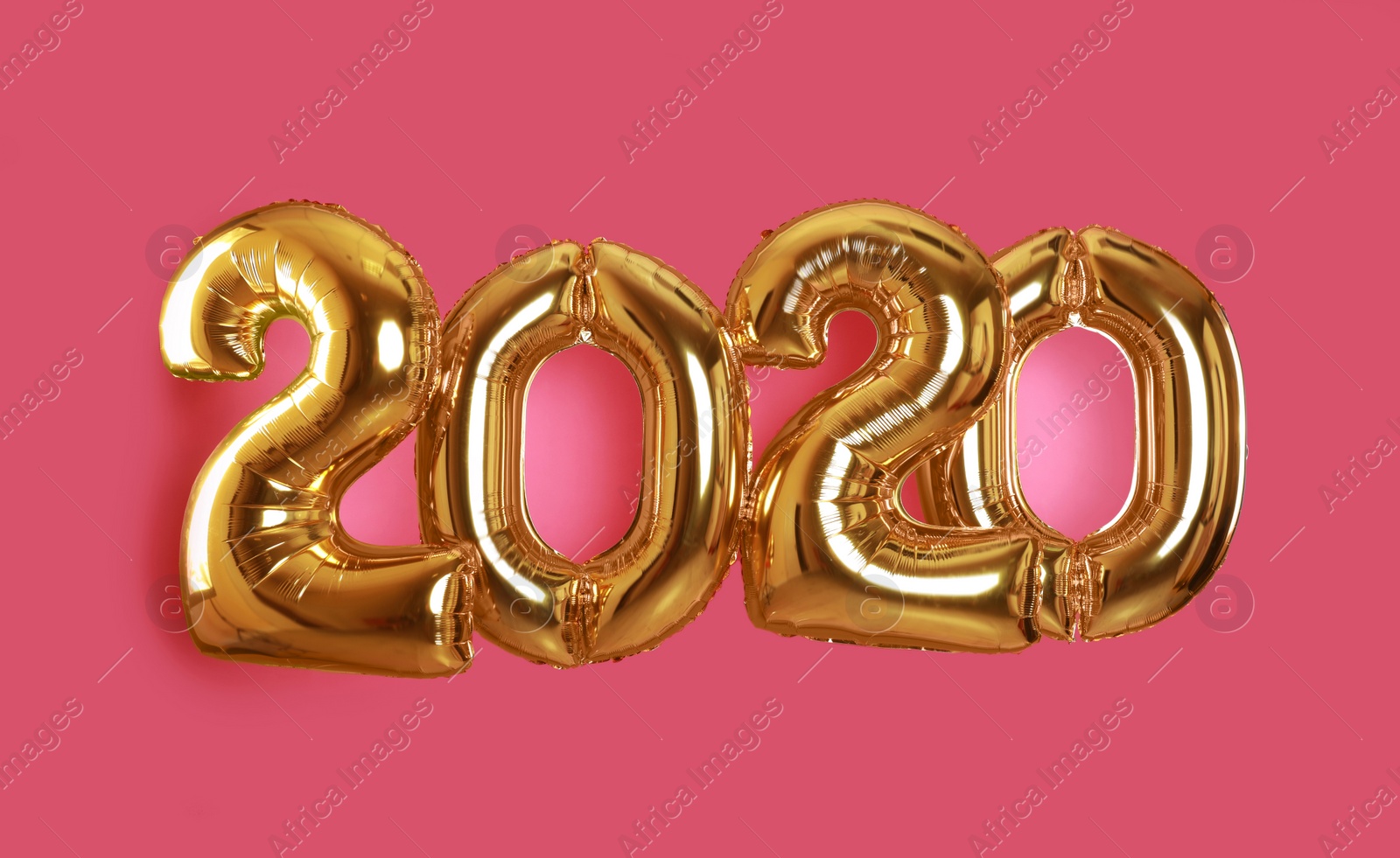 Photo of Golden balloons for party decoration on pink background. 2020 New Year celebration