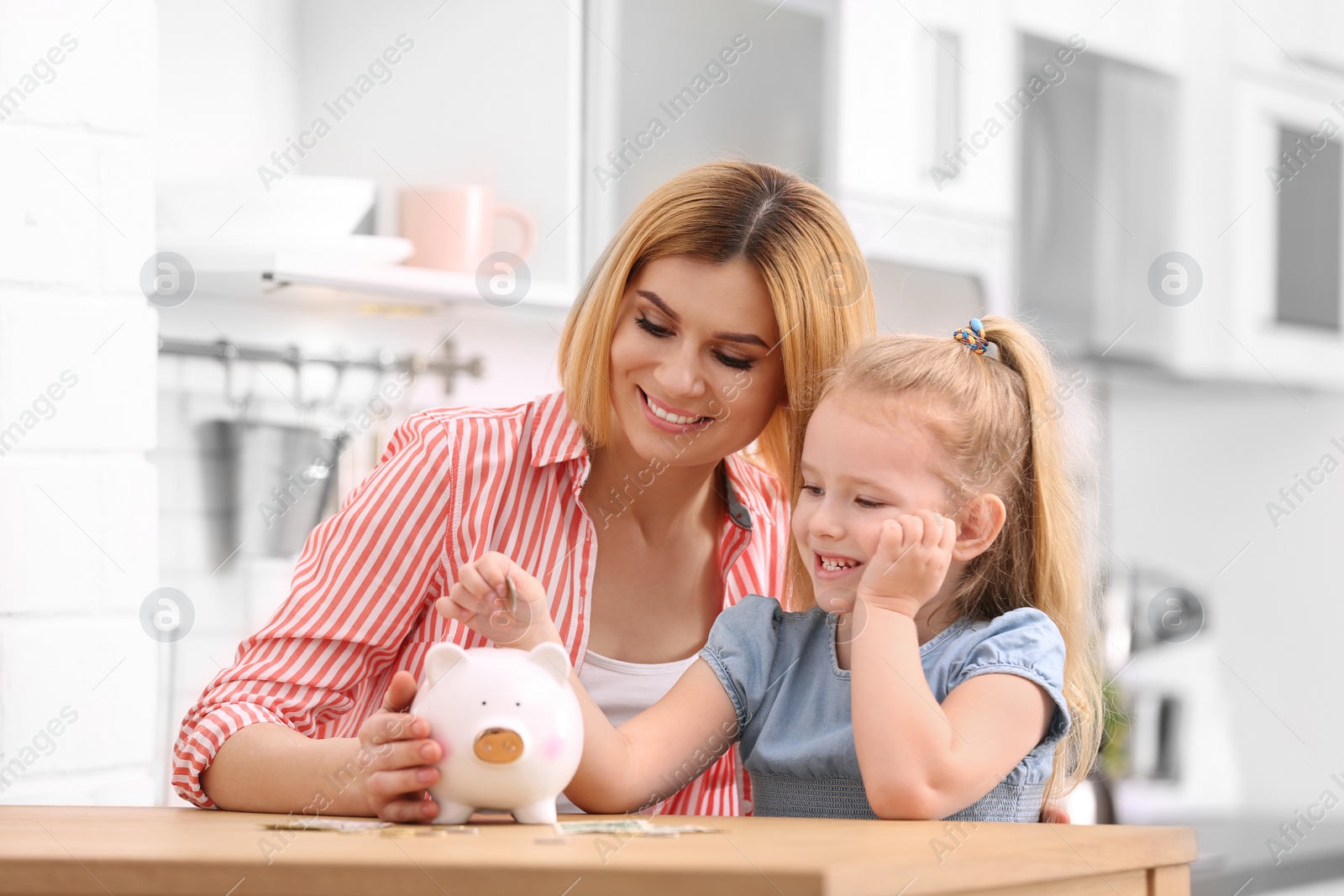 Photo of Family with piggy bank and money at home