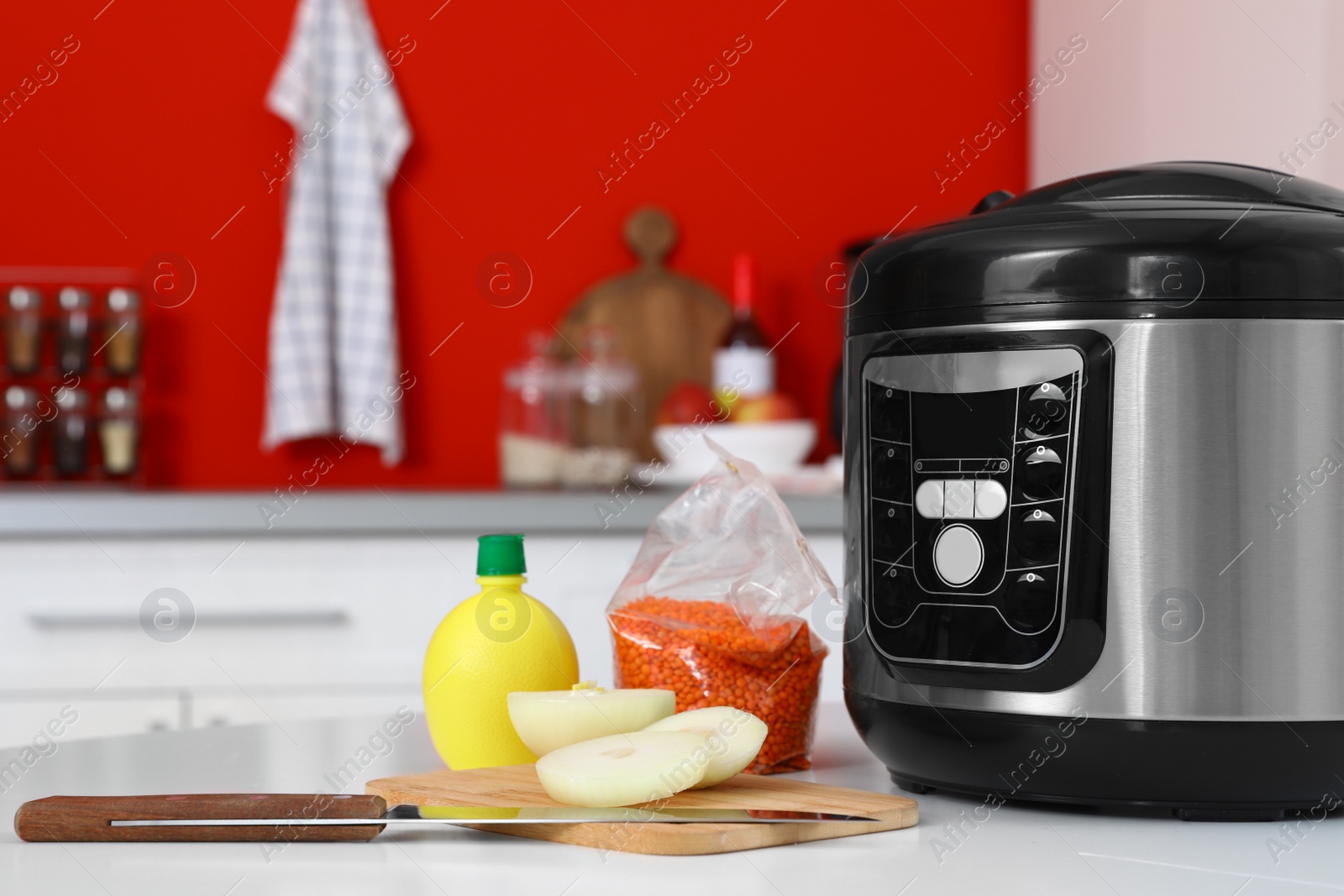 Photo of New modern multi cooker and products on table in kitchen. Space for text