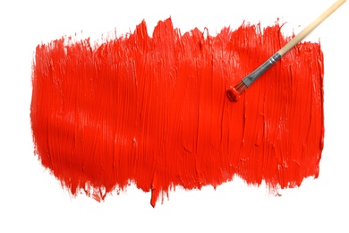 Photo of Paint stroke and brush on white background, top view