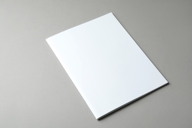 Brochure with blank cover on grey background. Mock up for design