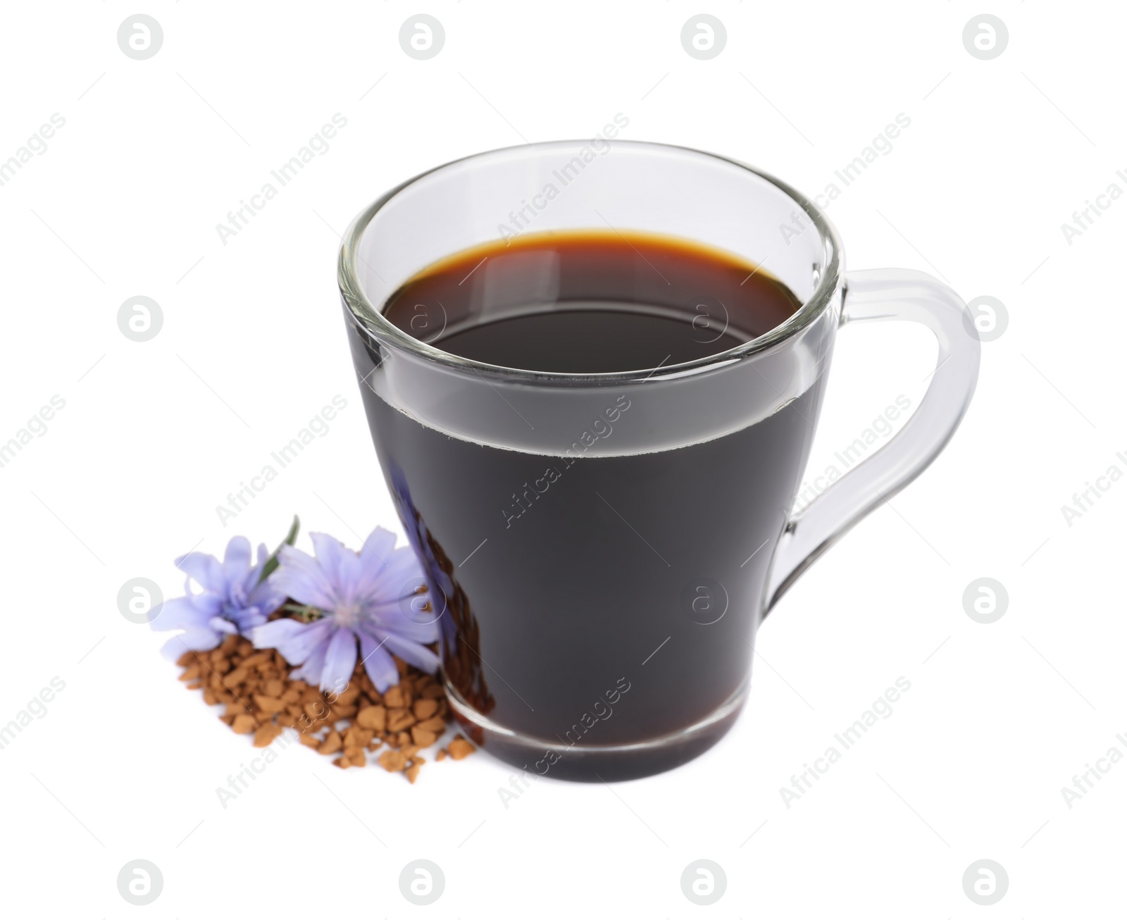 Photo of Glass cup of delicious chicory drink, granules and flowers on white background