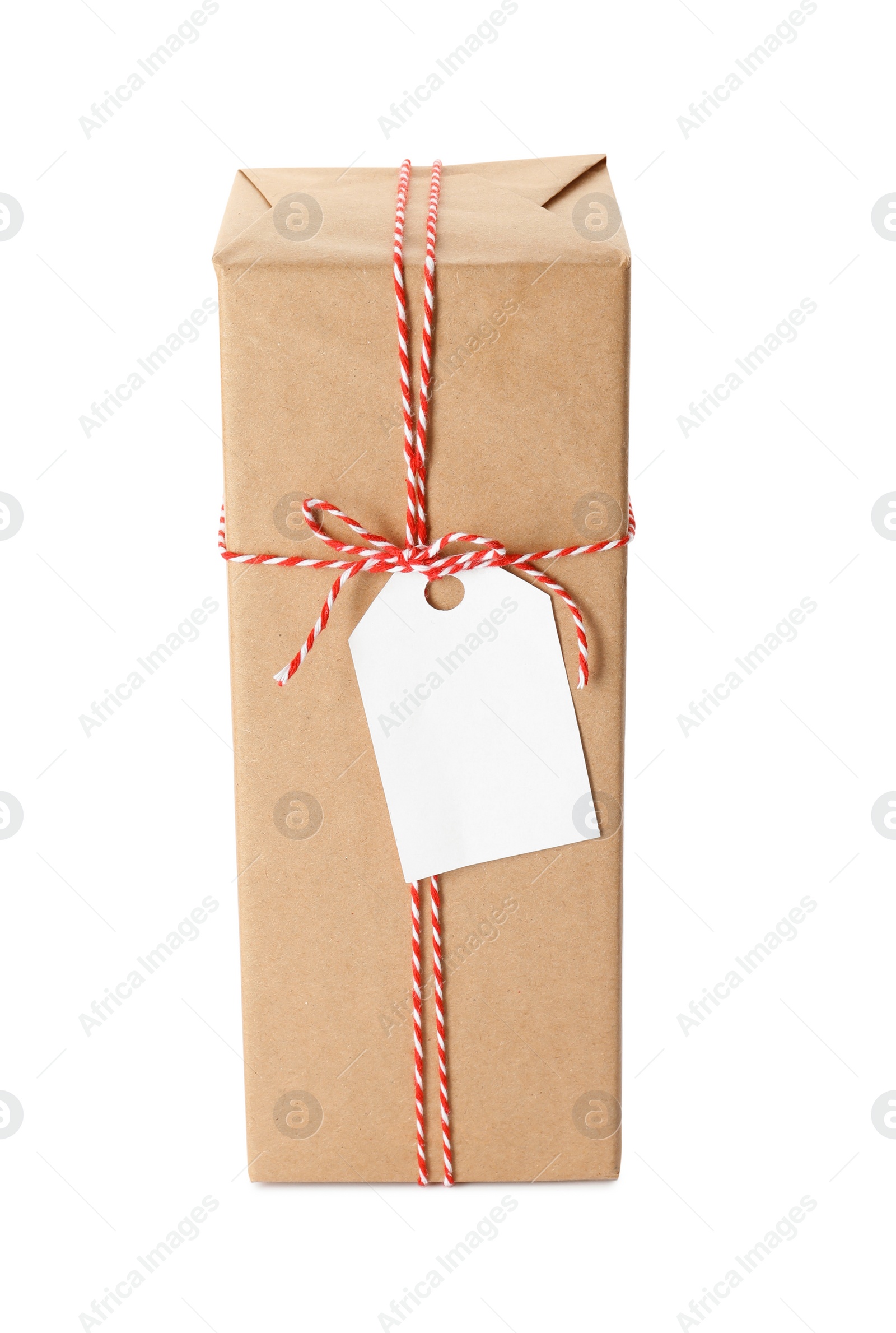 Photo of Gift box wrapped in kraft paper with bow and tag isolated on white