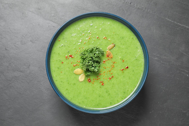 Photo of Tasty kale soup on grey table, top view