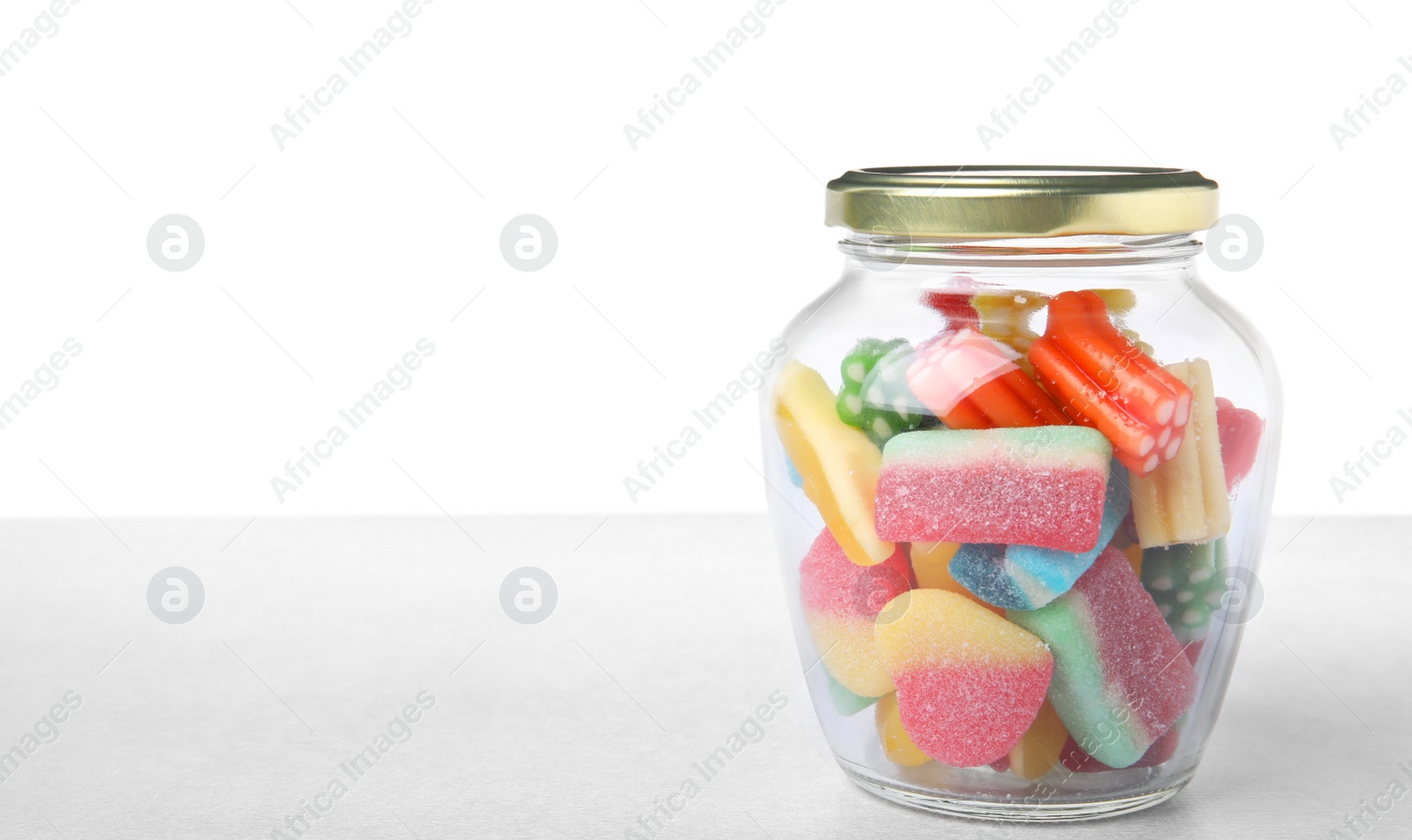 Photo of Tasty jelly candies in jar on light grey table