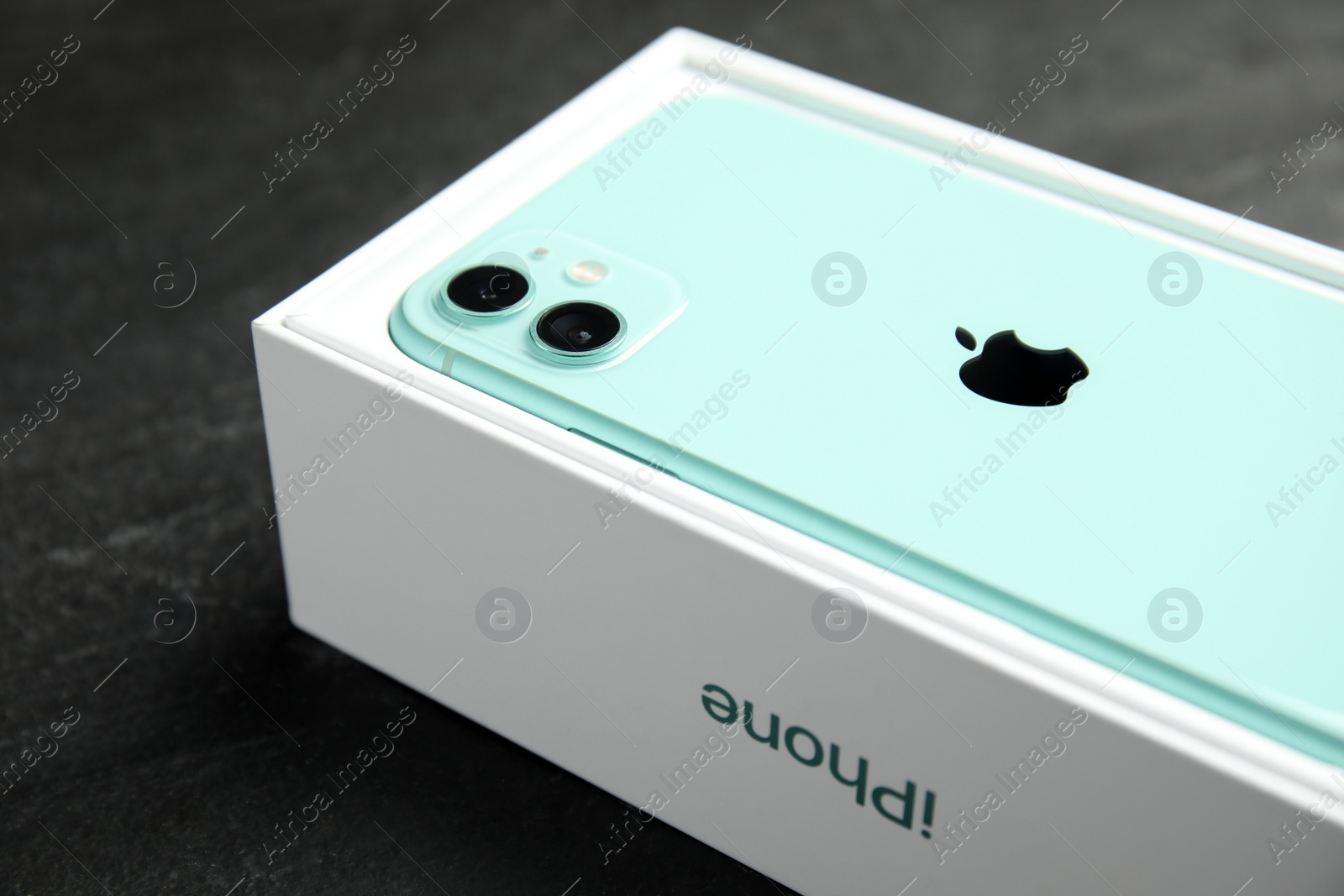 Photo of MYKOLAIV, UKRAINE - JULY 10, 2020: New modern Iphone 11 Green in original box on grey table, closeup