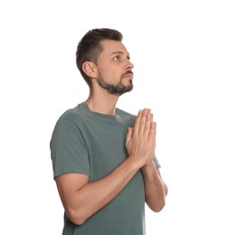Photo of Man with clasped hands praying on white background