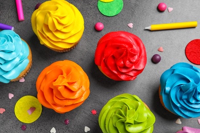 Delicious birthday cupcakes on gray background