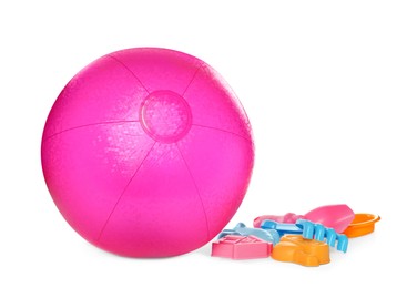 Inflatable pink beach ball and child plastic toys on white background