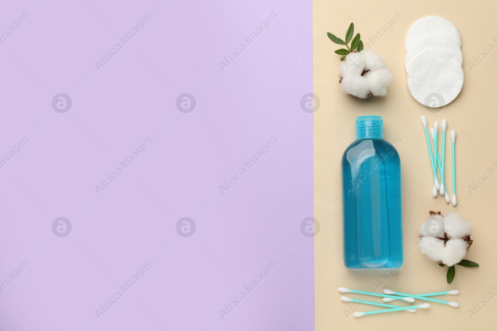 Photo of Cotton pads, swabs, flowers and makeup removal product on color background, flat lay. Space for text