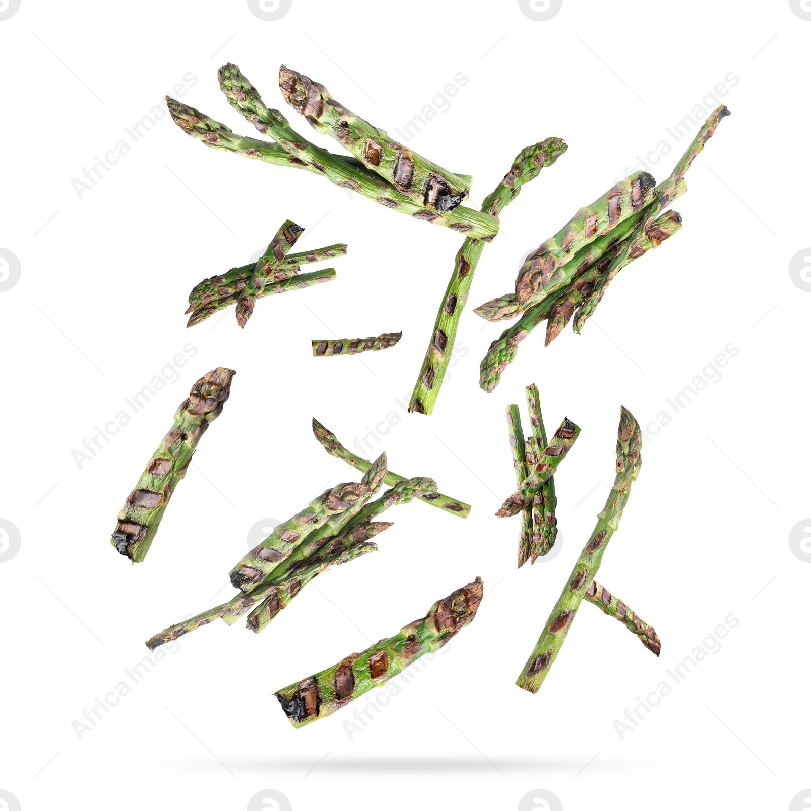 Image of Grilled asparagus spears in air on white background