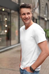 Portrait of handsome young man on city street