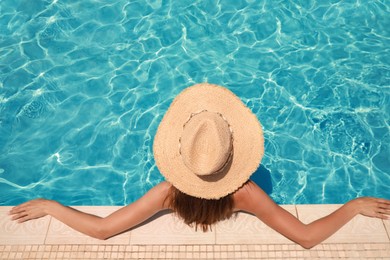 Photo of Woman wearing hat in swimming pool, above view