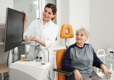 Photo of Senior woman visiting professional otolaryngologist in clinic. Hearing disorder