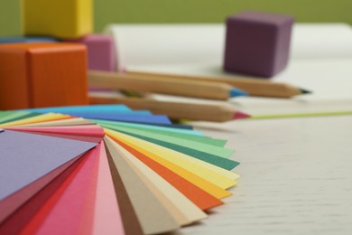 Photo of Color palette on white wooden table, closeup