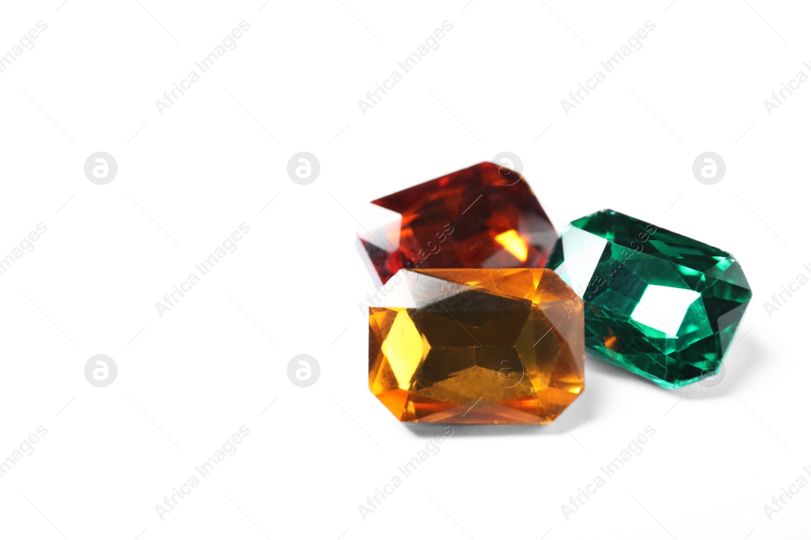 Photo of Different beautiful bright gemstones on white background