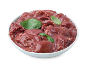 Photo of Plate of raw chicken liver with basil isolated on white