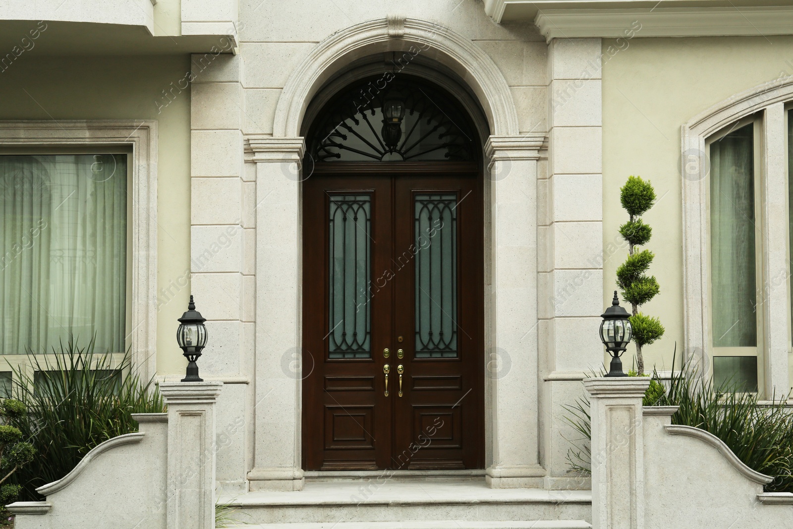 Photo of Beautiful wooden door with golden handles in building outdoors