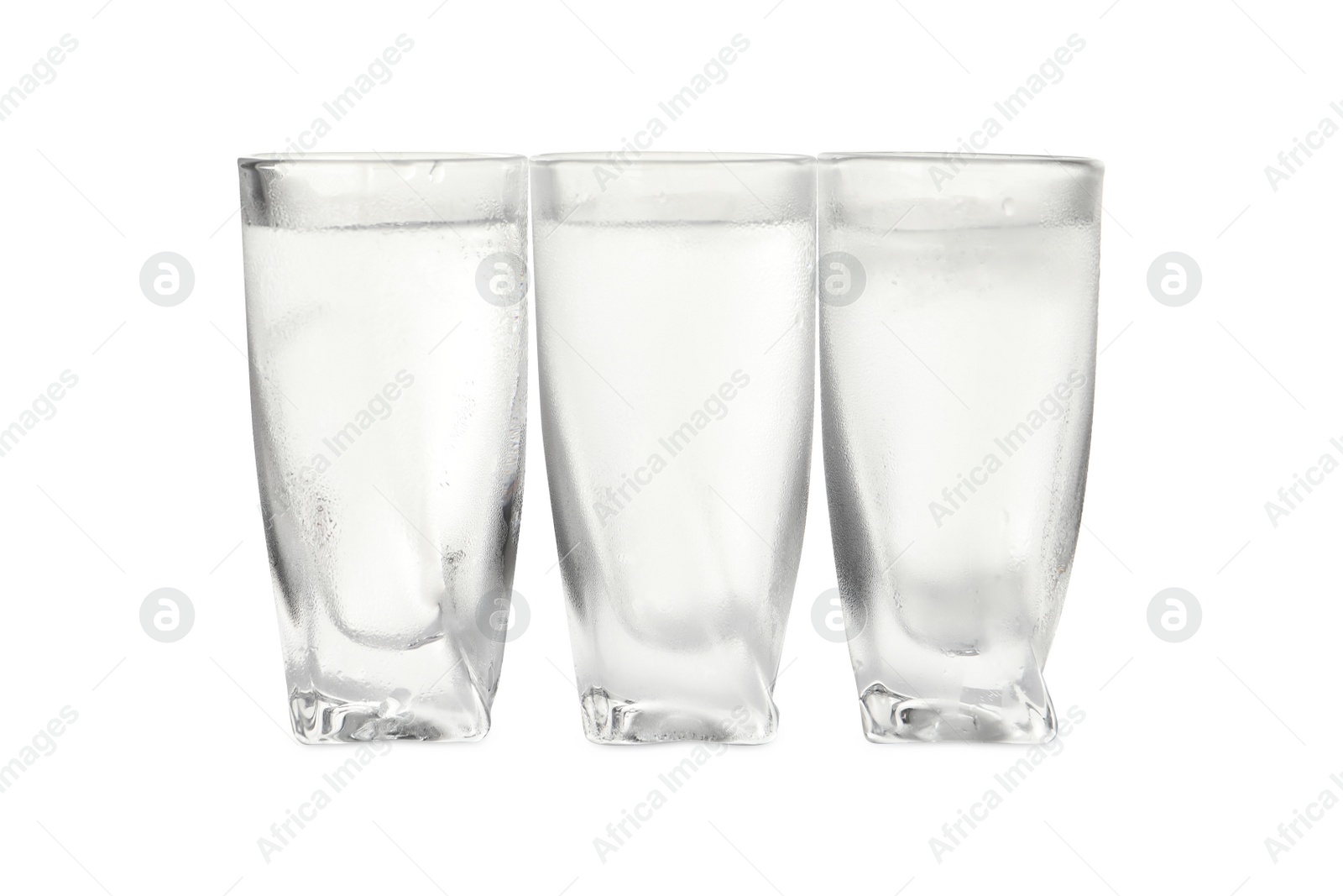 Photo of Vodka in shot glasses on white background