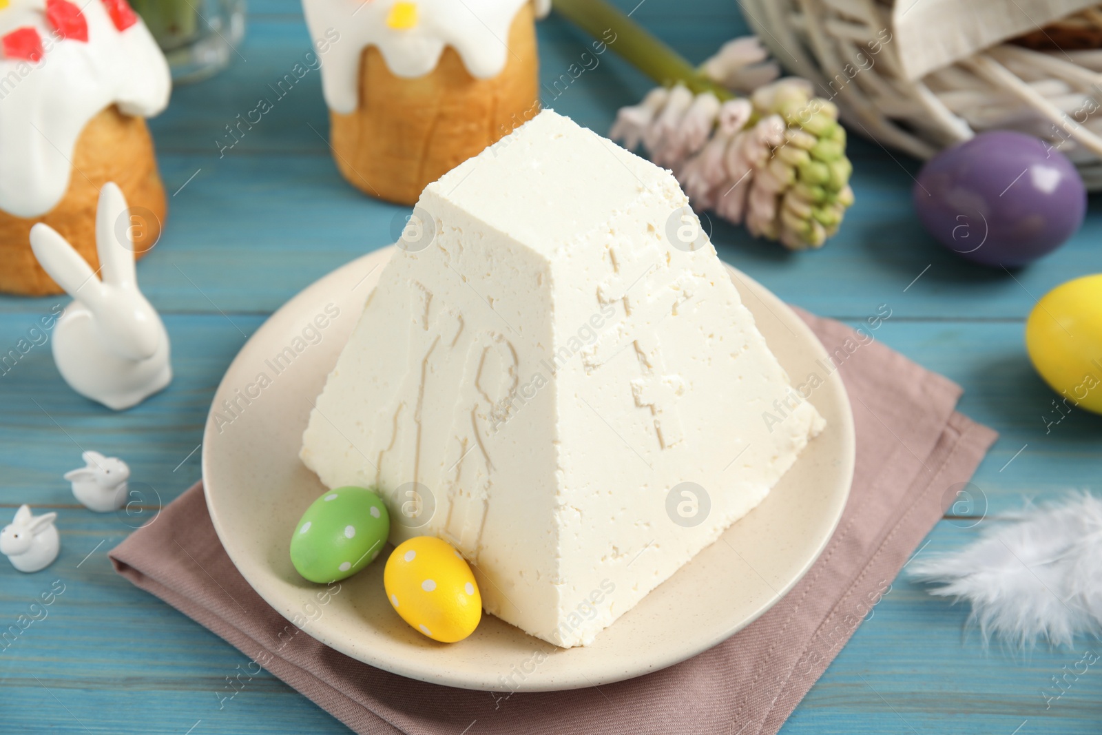 Photo of Traditional cottage cheese Easter paskha on light blue wooden table