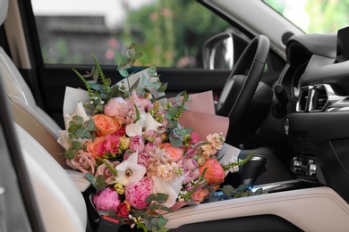 Photo of Beautiful flower bouquet inside car. Romantic surprise