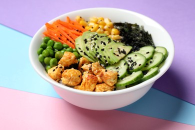 Photo of Delicious salad with chicken and vegetables on color background, closeup