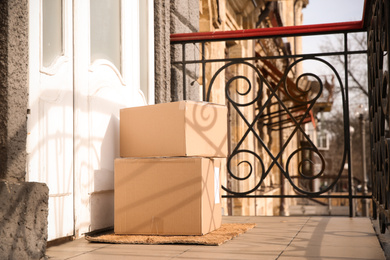 Photo of Delivered parcels on door mat near entrance