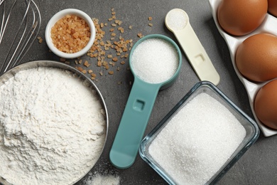 Photo of Flat lay composition with fresh ingredients for delicious homemade cake on grey table