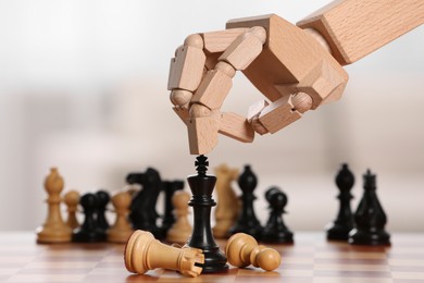 Photo of Robot playing chess, closeup. Wooden hand representing artificial intelligence